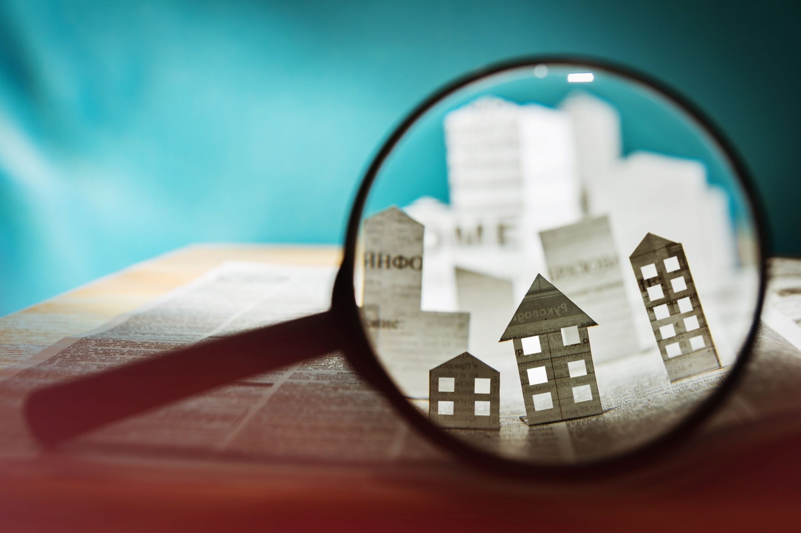 paper house under a magnifying lens 827615404 5ac03d77642dca00361f229d scaled